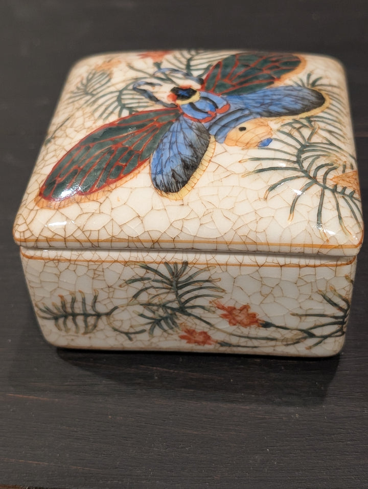 HomArt porcelain keepsake box with tropical insect lid and crackled ivory glaze, front view