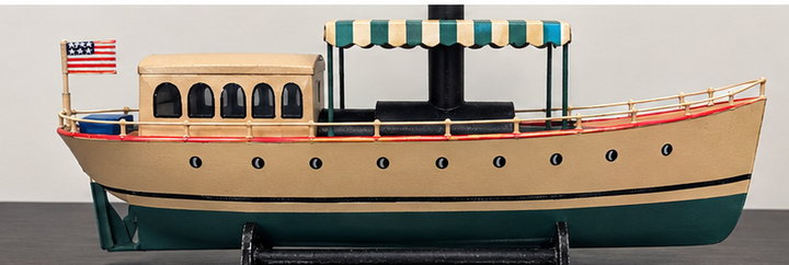Hand-painted African Queen model boat viewed from the stern with flag and cabin windows